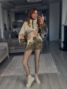 Off-white half-zip patterned women's sweatshirt.